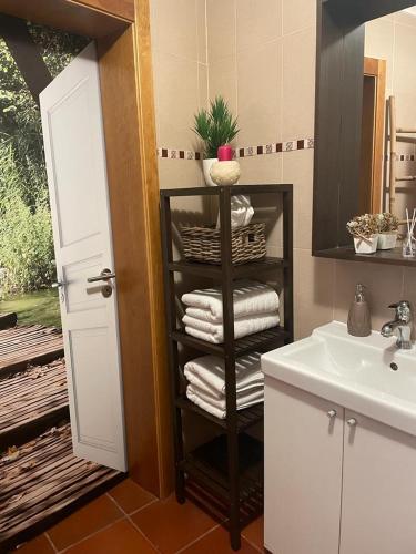 a bathroom with a black towel rack next to a sink at Alojamento JCP in Bombarral