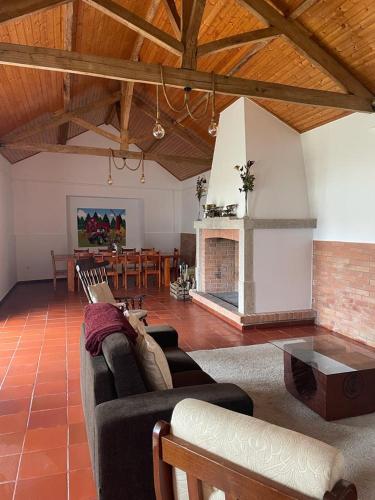 a living room with a couch and a fireplace at Alojamento JCP in Bombarral