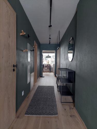 a hallway of a house with green walls and a door at Bergleben Maria Alm - Haus Panorama in Maria Alm am Steinernen Meer