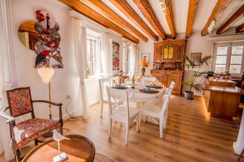 a dining room with a white table and chairs at Lighthouse apartment in Corfu Town