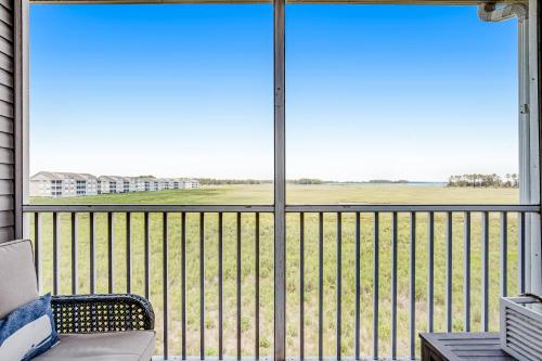 a balcony with a couch and a view of a field at Bethany Bay 2505 Harbor Dr in Ocean View