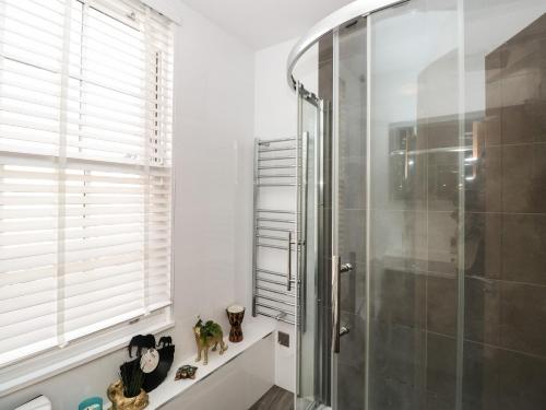 a shower stall in a bathroom with a window at Rock and Reel in Dartmouth