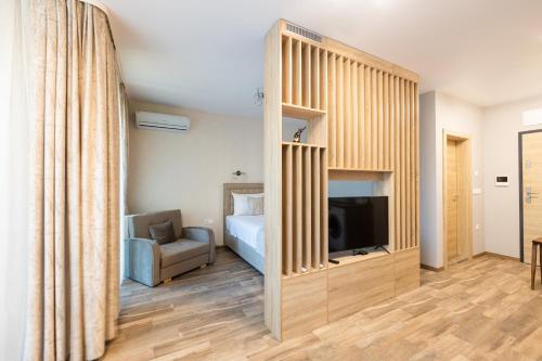 a bedroom with a bed and a tv in a room at Helena Holiday A in St. St. Constantine and Helena