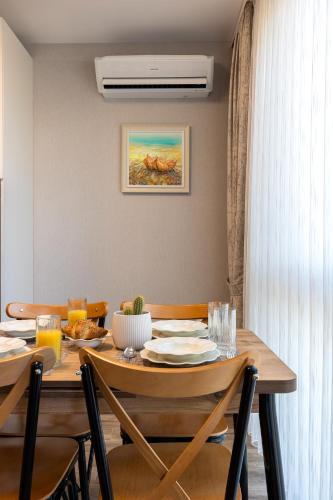 a dining room with a wooden table with chairs at Helena Holiday A in Saints Constantine and Helena