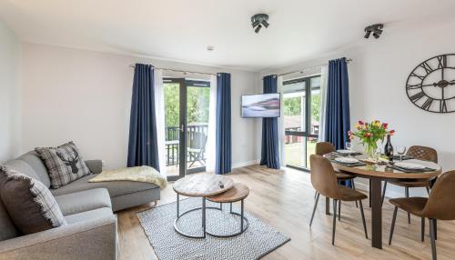 a living room with a couch and a table at High Range Holiday Apartments in Aviemore