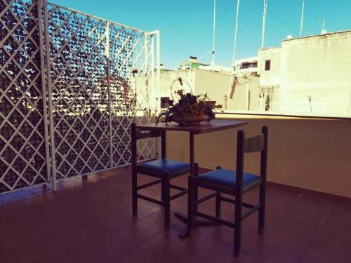 a table and two chairs on a balcony at Olympo in Bisceglie