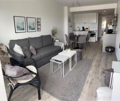 a living room with a couch and a table at Lägenhetshotell Varvet in Ellös