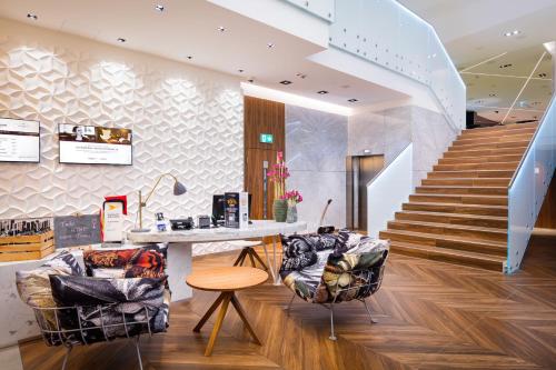 a living room filled with furniture and a staircase at Mercure Krakow Stare Miasto in Krakow