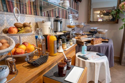 a kitchen with a bunch of food on a counter at Logis Hôtels Restaurant Les 3 Rois in Issoudun