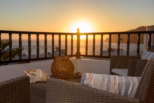 a table with chairs and a vase on a balcony at Galaxy in Aegiali