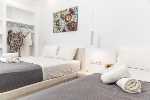 a bedroom with two beds and a painting on the wall at Depis castle Renata luxury apartments in Naxos Chora