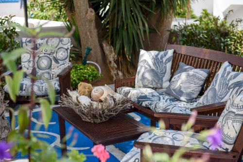 a couch and a table with pillows on it at Galaxy in Aegiali