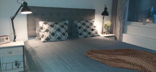 a bedroom with a large bed with two pillows at Lägenhetshotell Varvet in Ellös