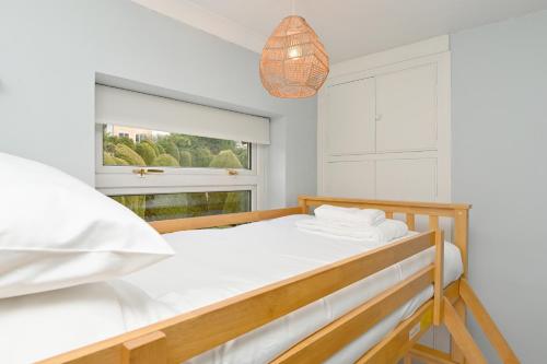 a bedroom with a bed and a window at Derwent Valley View in Whatstandwell