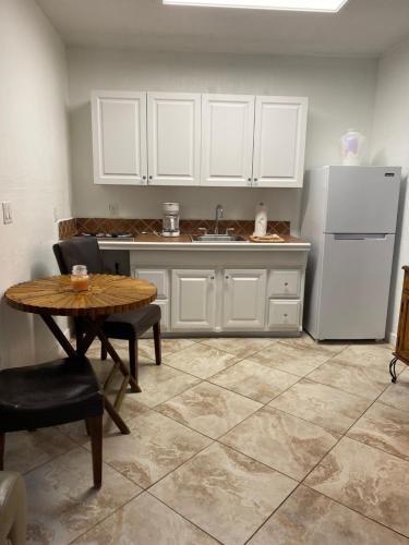 a kitchen with a table and a refrigerator at The Inn at Turtle Beach (Adults Only) in Siesta Key