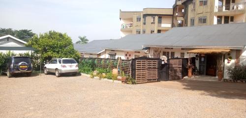 a car parked in front of a house with a fence at Dream jet suites in Entebbe