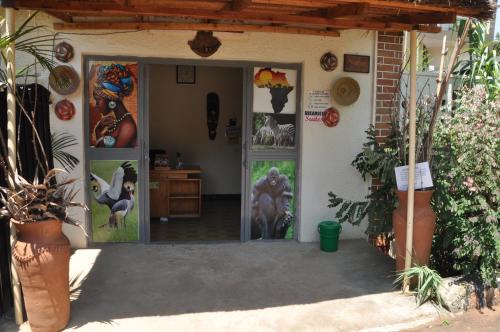 an entrance to a house with paintings on the door at Dream jet suites in Entebbe