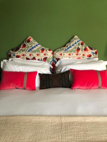 a bed with three pillows at The Inn at Loch Tummel in Tummel Bridge