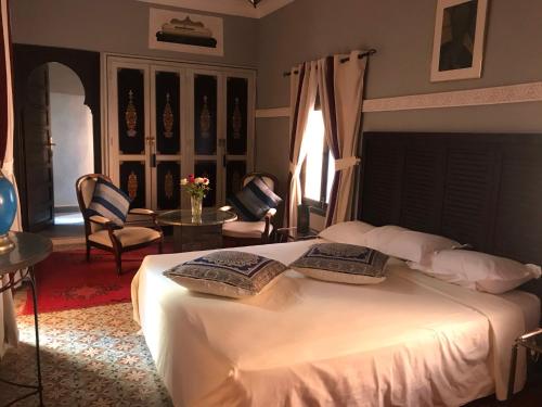 a bedroom with a bed with two pillows on it at Riad Syba in Marrakesh