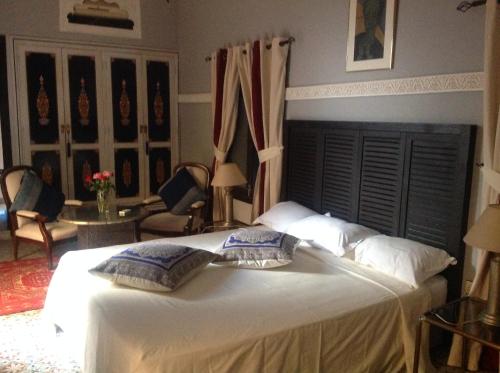 a bedroom with a bed with two pillows on it at Riad Syba in Marrakech