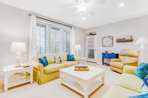 a living room with two couches and a table at Bear Trap Dunes - 124G October Glory in Ocean View