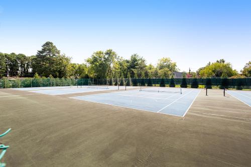 a tennis court with four tennis rackets on it at Bethany West - 609 Brookview in Bethany Beach