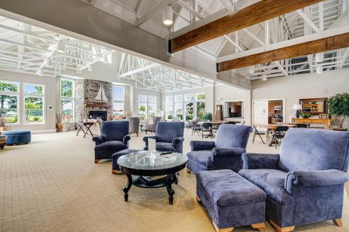 a living room with blue couches and a table at Bayside Bethany Lakes - S Mill #177 in Ocean View