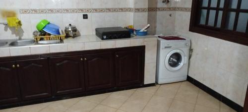 a kitchen with a sink and a washing machine at Leila in Agadir