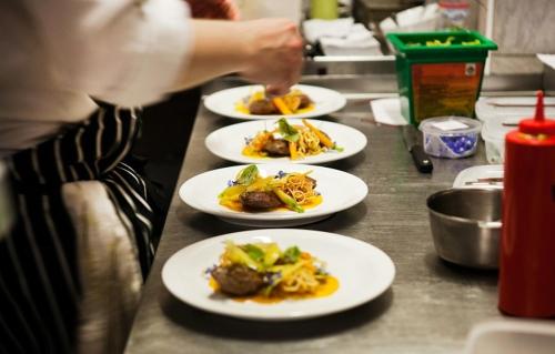 a row of plates of food on a counter at Hotel Graffit in Świebodzin