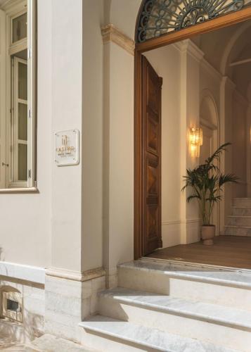 an entrance to a building with a door and a potted plant at Castro Hotel Syros in Ermoupoli