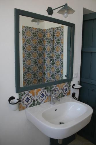 a bathroom with a sink and a mirror at Agriturismo Masseria Acque Di Palermo in Roccapalumba