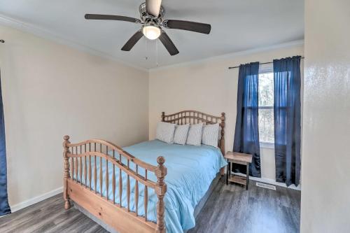 a bedroom with a bed and a ceiling fan at Dog-Friendly House with Yard Near Boat Launch! in New Bern