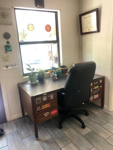 an office with a desk with a chair and a window at Butterfly Ranch in St Petersburg