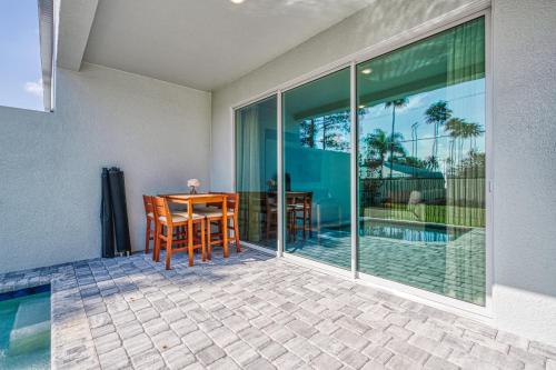 a patio with a table and chairs next to a pool at Formosa Valley by UNE Homes in Orlando