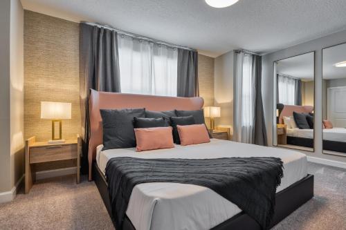 a bedroom with a large bed with two pillows at Formosa Valley by UNE Homes in Orlando