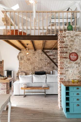 a living room with a couch and a loft at Casa Trilhos da Serra in Alcobertas