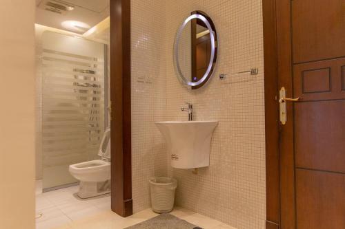 a bathroom with a sink and a toilet at Mostar Resort in Riyadh