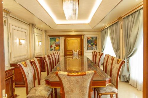 a dining room with a long table and chairs at Mostar Resort in Riyadh