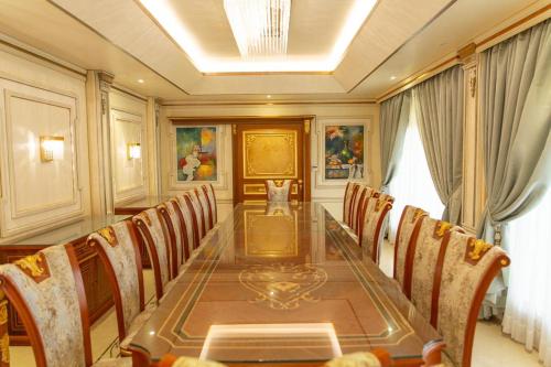 a dining room with a long table and chairs at Mostar Resort in Riyadh