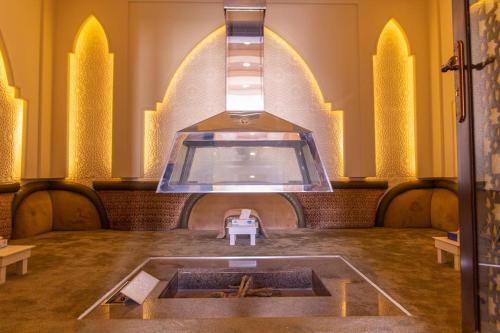 a room with a fountain in the middle of a building at Mostar Resort in Riyadh