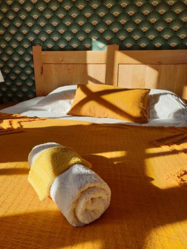 a towel is laying on top of a bed at Là-Haut "Maison d'hôtes" in Antraigues