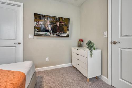 a bedroom with a white dresser and a picture on the wall at Formosa Valley by UNE Homes in Orlando