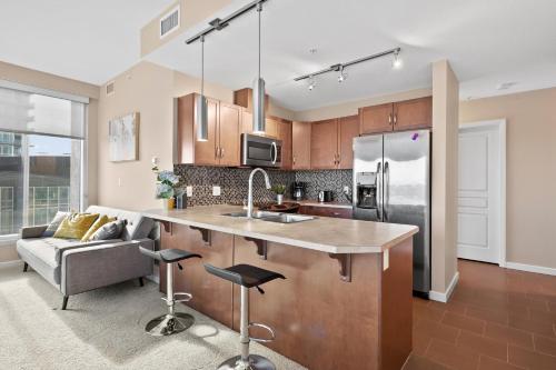 a kitchen with a sink and a counter top at Stylish Downtown Condos by GLOBALSTAY in Calgary