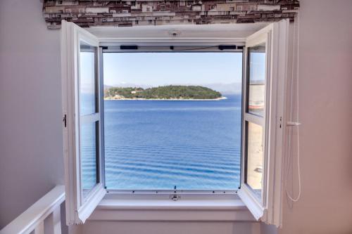an open window with a view of the ocean at Lighthouse apartment in Corfu Town