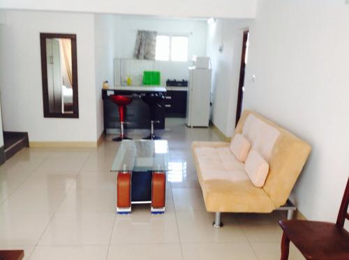 a living room with a couch and a table at Silver Sands in Flic-en-Flac