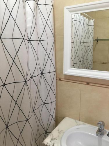 a bathroom with a white sink and a mirror at Casa Quintião in Ferragudo