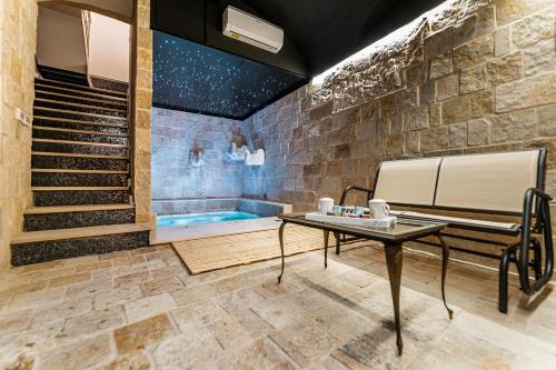 a room with a table and a bath tub at Fountain - Suite Santeramo in Santeramo in Colle