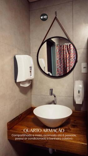 a bathroom with a sink and a mirror at Graffi Beach House in Florianópolis