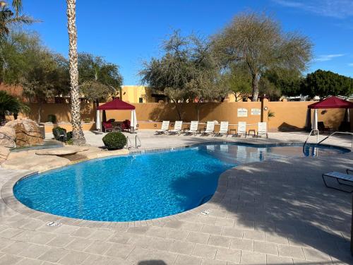 a swimming pool in a resort with chairs and trees at Monte Vista Village Resort Mesa 3 Bed 2 Bath Age Restricted Must be 55 or more in Mesa