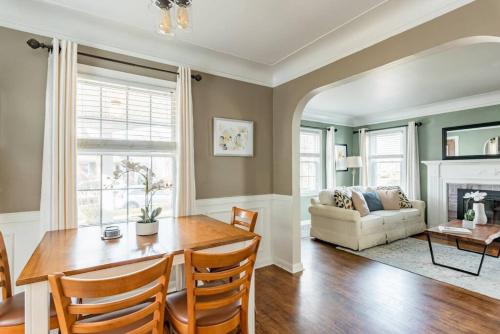 a living room with a table and chairs and a couch at Pet Friendly - Large Families - Heart of Royal Oak - 5 Smart TVs in Royal Oak